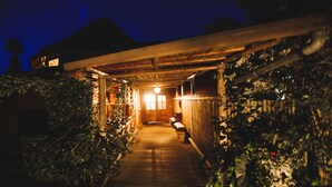 A wooden pathway leading to a building with a covered entrance, surrounded by greenery. - Ingagi Park View Lodge (Kinigi)