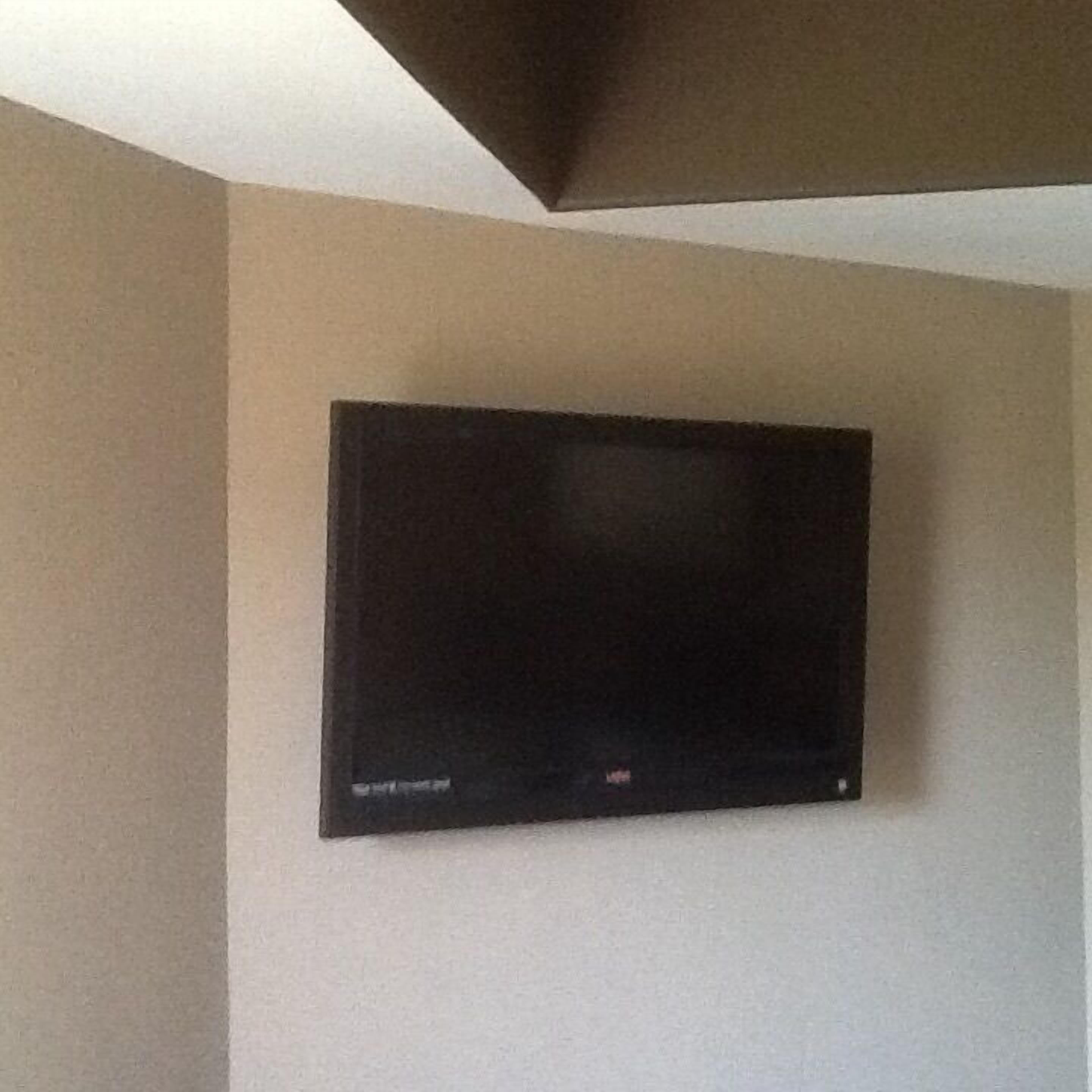 A flat-screen TV mounted on a plain wall.