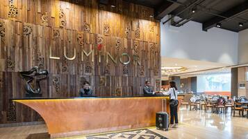 A reception area with a wooden wall displaying the name 'LUMINOR'.