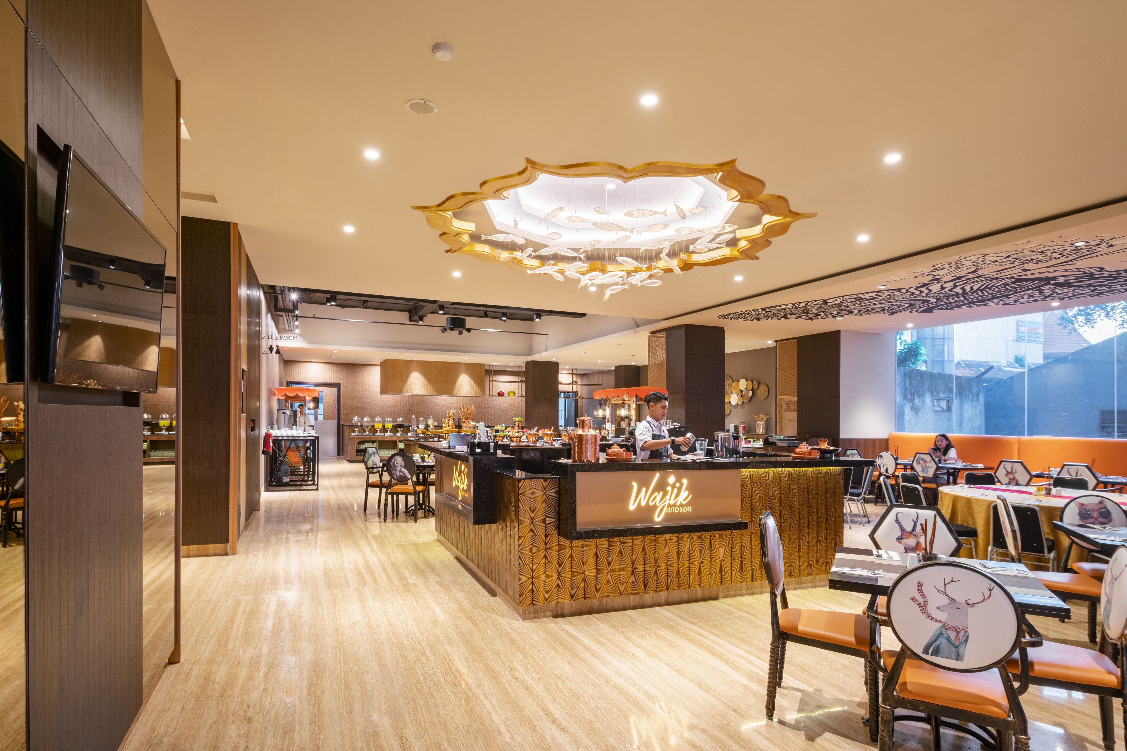 A restaurant with a central counter, multiple tables, and chairs.
