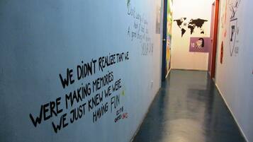 A hallway with motivational quotes and a world map on the wall.