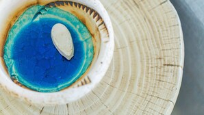 A close-up of a ceramic bowl with a blue interior and a white object inside. - 3-bedroom villa close to the beach at Triton SeaView Villas with common poolS (Asprouliani)