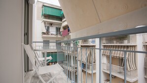 A multi-story residential building with balconies, a staircase, and a view of neighboring buildings. - Gold and Blue Luxurious Apartment (Athens)