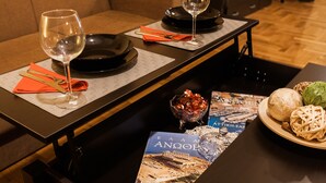A dining table set with wine glasses, cutlery, and a menu. - Spacious Safe Apartment Walk Acropolis (Athens)