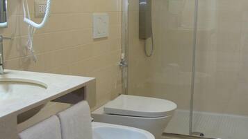 A bathroom with a sink, toilet, and shower.