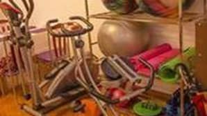 A room with exercise equipment, including a stationary bike and a treadmill, and a rack with colorful exercise balls. - Adler Lady Guesthouse - Women Only (Yangon)