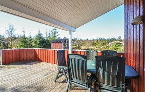 Enjoy outdoor dining or relaxation on this deck with forest views.