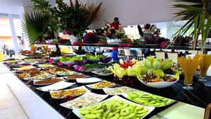 A buffet with various food items and decorative plants. - Monna Roza Beach Resort Hotel (Kemer)