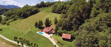 Escape to a serene retreat surrounded by lush greenery and a pool.