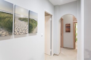 A hallway with a white wall and a door leading to another room. - Central Safe Smart Apartment (Athens)