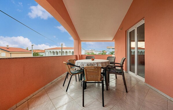 Enjoy a meal or a moment of peace on this balcony with a round table and six chairs.