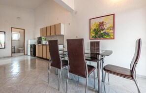 Enjoy meals in this stylish dining area with a glass-top table and comfortable leather chairs.