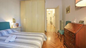 A hotel room with a bed, a dresser, a mirror, and a wardrobe. - Awesome apartment in Rapallo (GE) (Rapallo (GE))