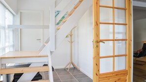 A staircase with wooden steps and a glass door leading to another room. - Cozy home in Lemvig with WiFi (Lemvig)