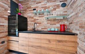 Fridge, stovetop, dishwasher, coffee/tea maker