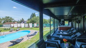 A poolside area with lounge chairs and a bar. - Gorgeous home in Fericanci with sauna (Fericanci)