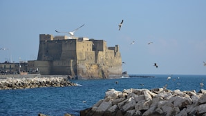A coastal castle with a rocky breakwater in the foreground. - Dimora Megaride (Naples)
