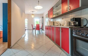 Enjoy meals in the kitchen with a stainless steel range hood and dining area.