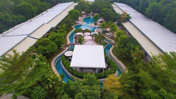 Una piscina al aire libre, sombrillas, sillones reclinables de piscina