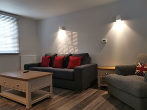Duplex supérieur, 2 chambres, non-fumeur, vue sur le fleuve | Aire de séjour | Téléviseur connecté, lecteur de DVD, station d’accueil pour iPod