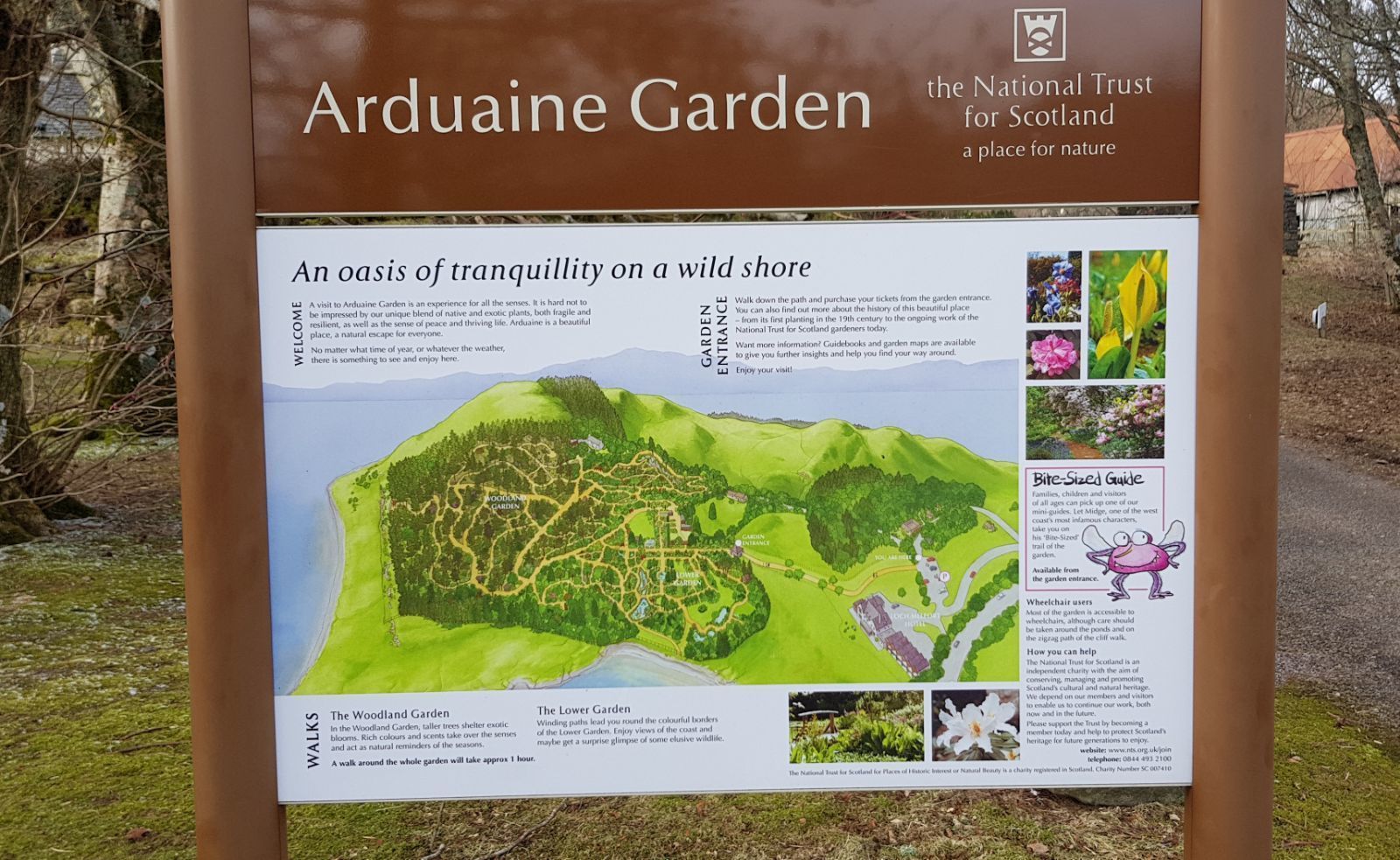 A sign for Ardouaine Garden, detailing its tranquil setting and layout.