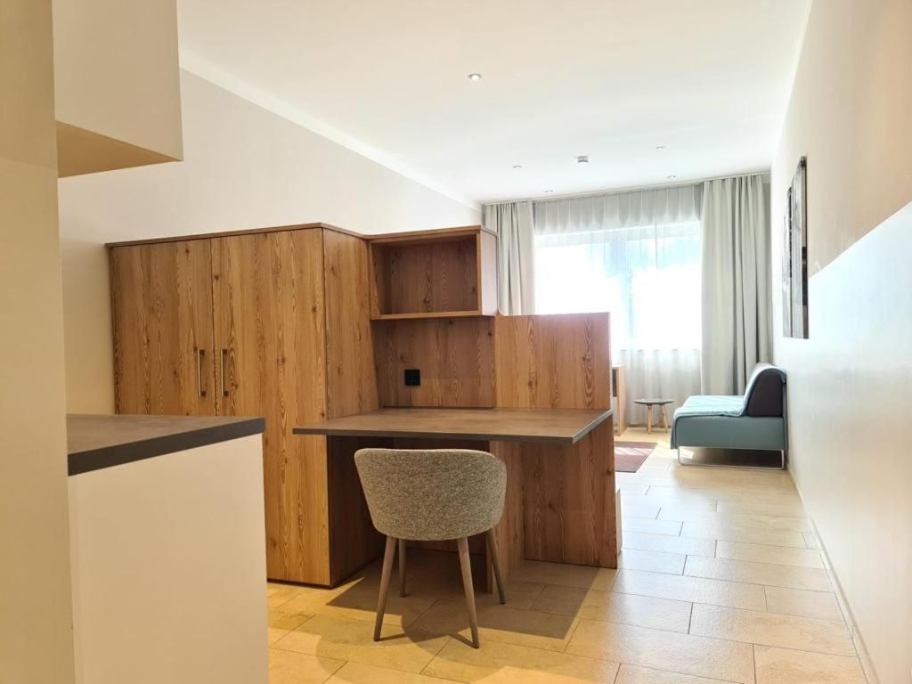 A compact living space with a kitchenette, a dining area, and a seating area.