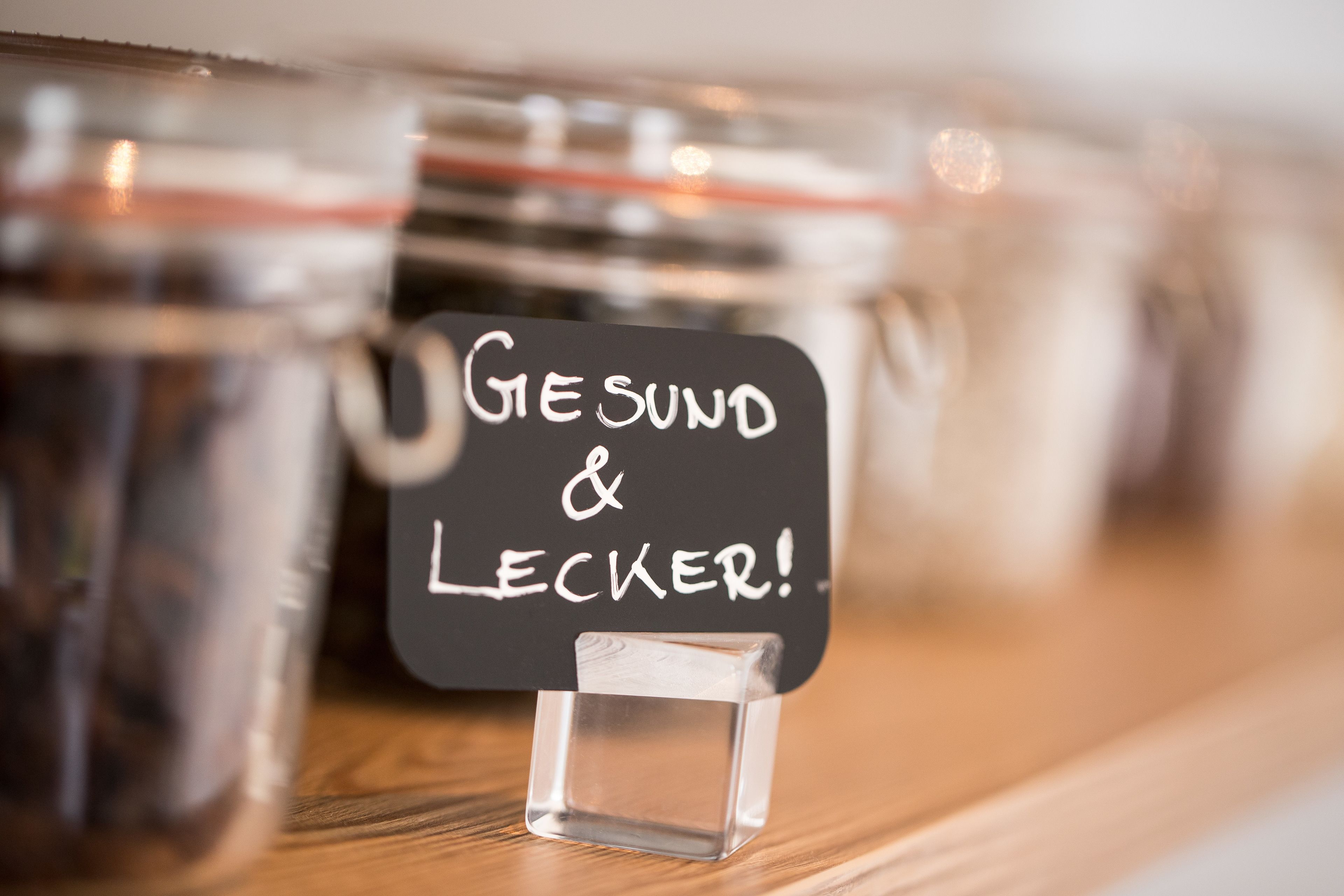 A clear glass jar with a black label that reads "GESUND & LECKER!"