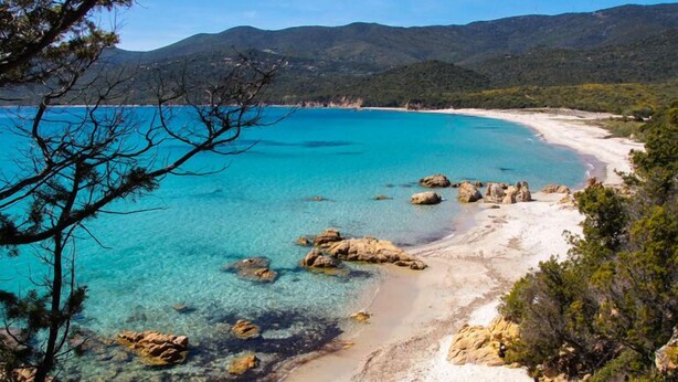 A coastal landscape with clear turquoise waters, rocky outcrops, and a sandy beach. - Résidence La Plage (Olmeto)