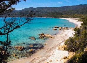 A coastal landscape with clear turquoise waters, rocky outcrops, and a sandy beach. - Résidence La Plage (Olmeto)