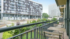 A modern apartment building with balconies, a rooftop garden, and a view of a neighboring building. - Alcam Anglesola (Barcelona)
