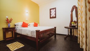 Un dormitorio con una cama de madera, una mesita de noche, un espejo y una lámpara de pared.