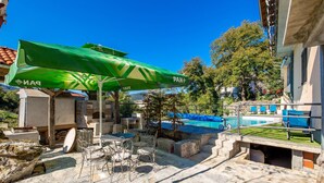 A patio area with outdoor seating, a pool, and a stone oven. - Gorgeous home in Vele Mune (Vele Mune)