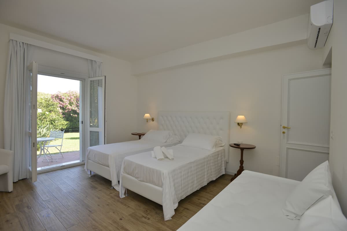 Triple Room, Garden View, Ground Floor | Minibar, in-room safe, desk, blackout curtains