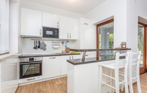 Fridge, stovetop, dishwasher, coffee/tea maker