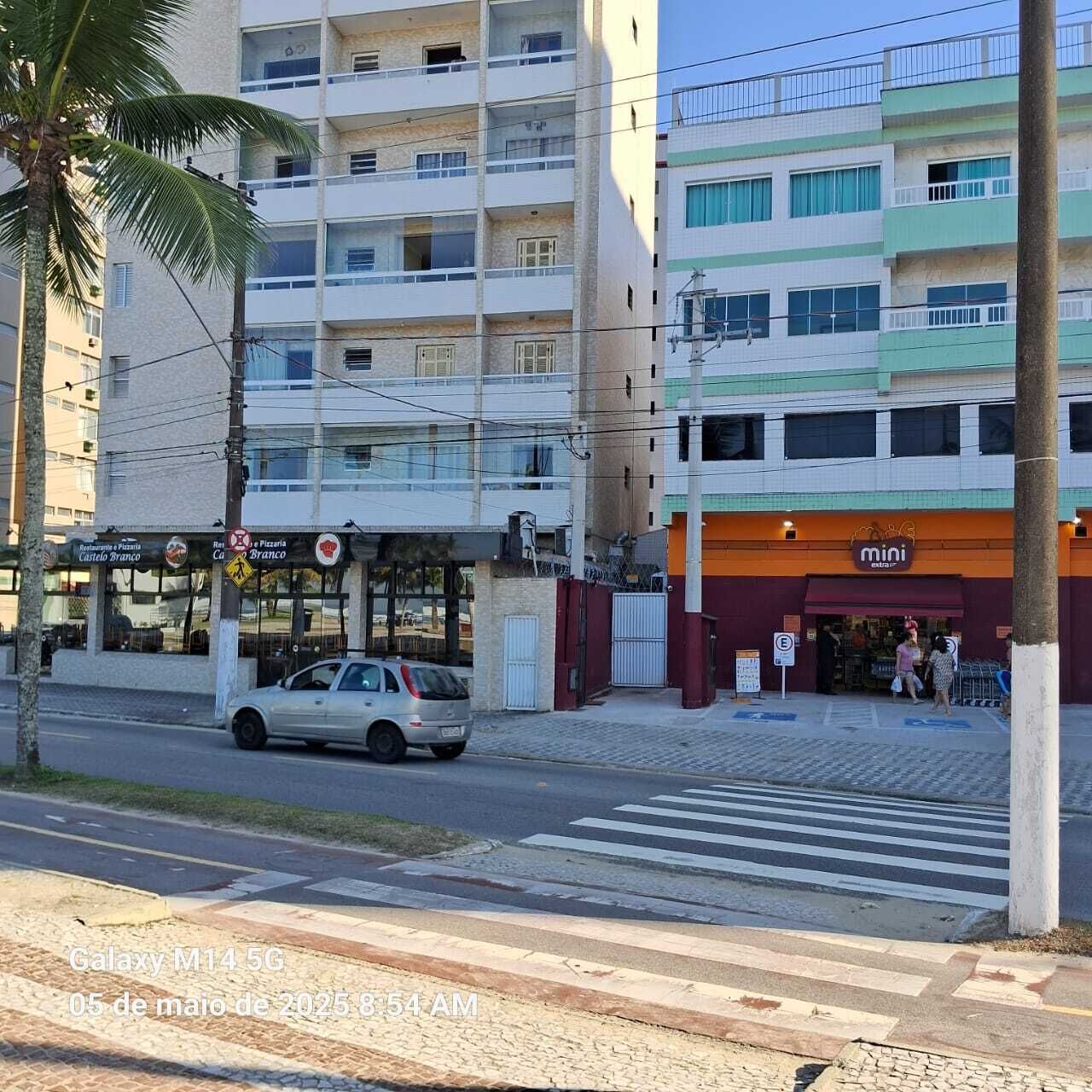 A multi-story building with a ground-floor restaurant and a 'mini' store.