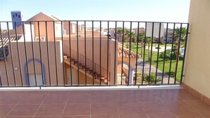 A balcony with a tiled floor and a metal railing. - Nice and complete apartment in playa oliva / denia (El Verger)