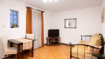 Apartment, 1 Bedroom | Living area | Flat-screen TV
