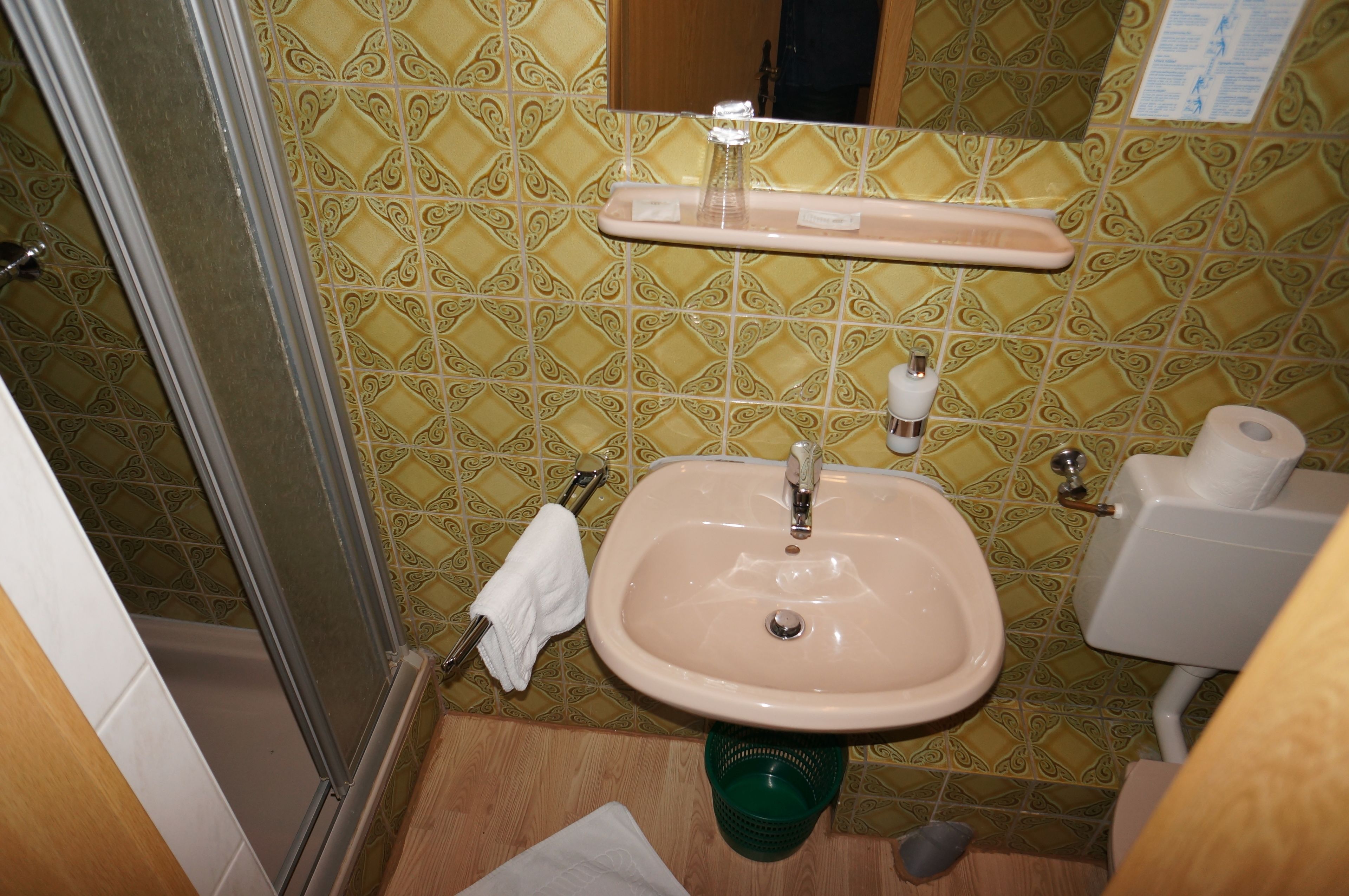A bathroom with a sink, toilet, and shower.