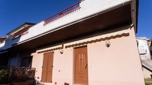 A two-story building with a balcony, a wooden door, and a small porch. - N044 - Numana, new three-room apartment with terrace and a / c (Numana)