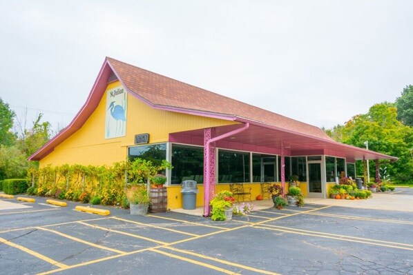 A yellow building with a red roof and a sign reading "St. Julian". - Association Pool Close To Beach & Downtown! (Union Pier)