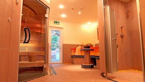A hotel lobby with a reception desk, a shower area, and a glass door leading outside.
