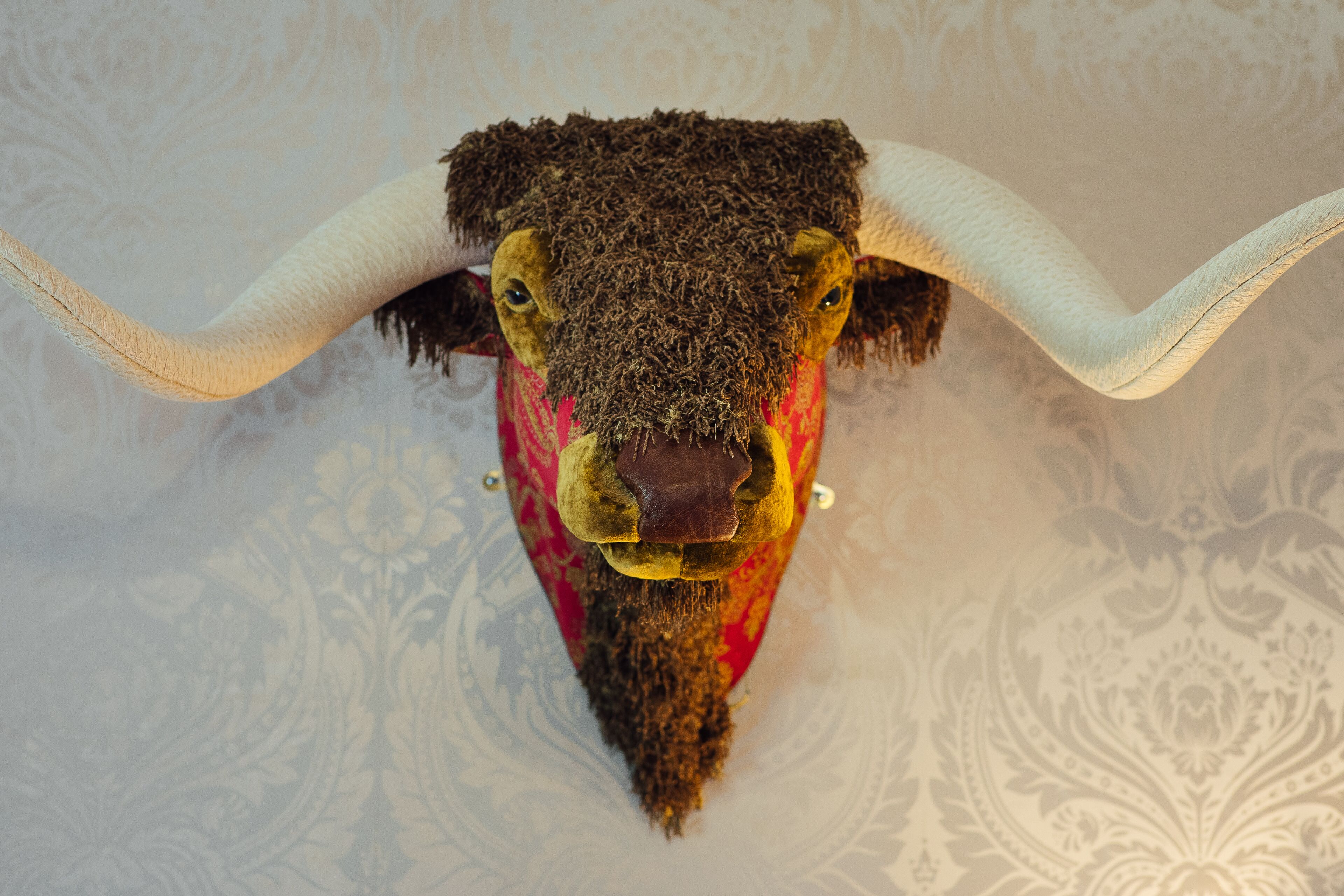 A stuffed animal with large horns and a textured head.