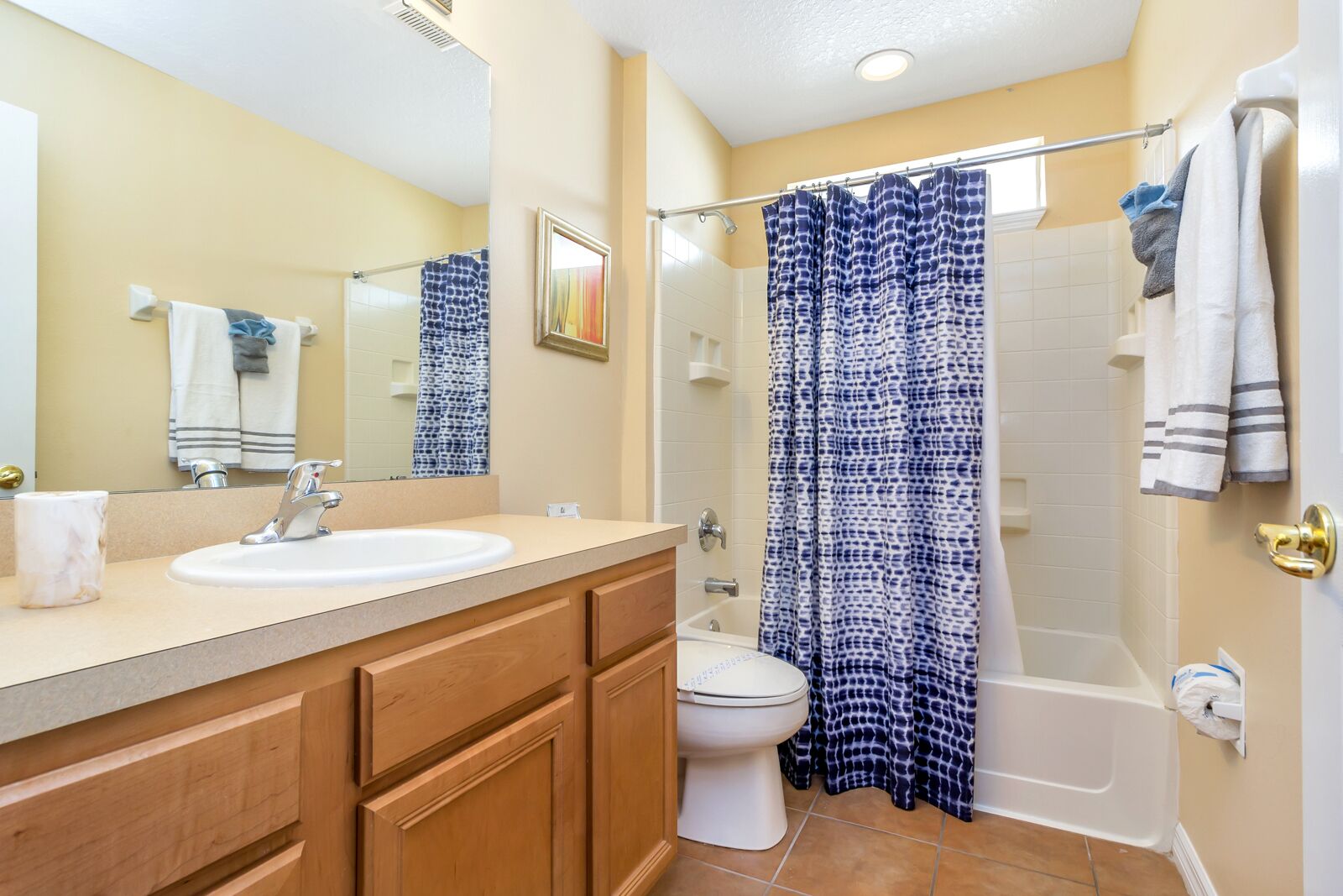 A bathroom with a sink, toilet, and bathtub.