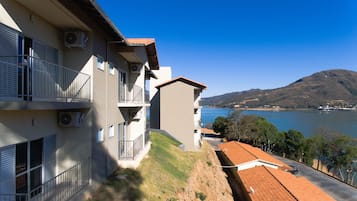 Enjoy breathtaking views of the serene lake and distant mountains from this residential building's balcony.