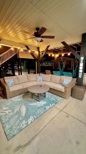 Relax in the inviting outdoor seating area with a comfortable sofa, chairs, and coffee table.