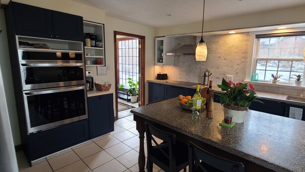 A modern kitchen with built-in ovens, a granite countertop, and a window overlooking the city. - Quiet & private in the heart of Peninsula, National Park and on the Towpath (Peninsula)