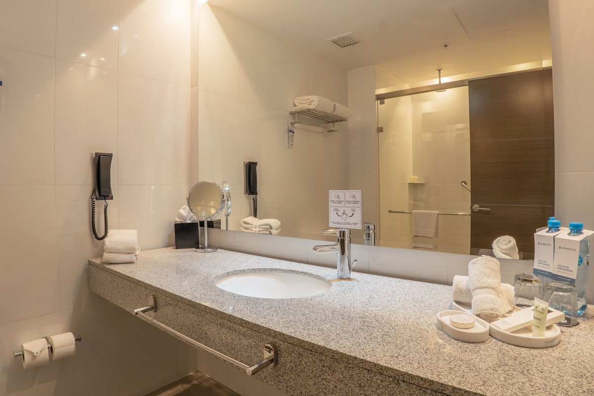 shower, rainfall showerhead, hair dryer, towels