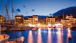 A marina at dusk with boats docked, buildings in the background, and a clear sky. - Magnificent air-conditioned villa with private pool, 2 bedrooms 2 bathrooms (4 people) (Porto-Vecchio)