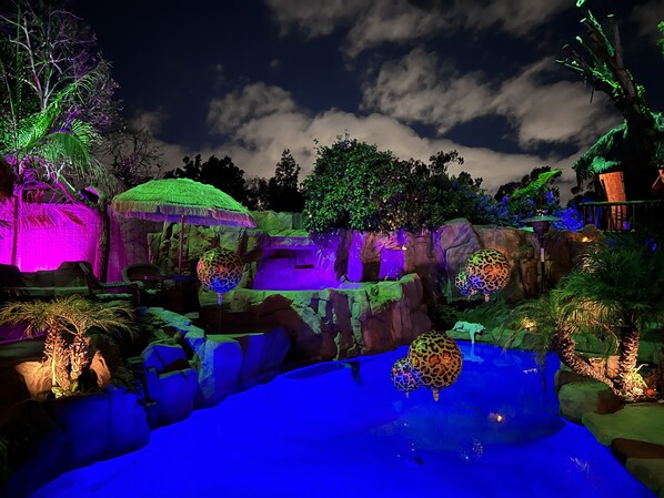 A nighttime scene of a zoo with illuminated animal enclosures and a large pond. - The Enchanted Manor- A Magical Hidden Oasis- Paradise!! (Valley Village)