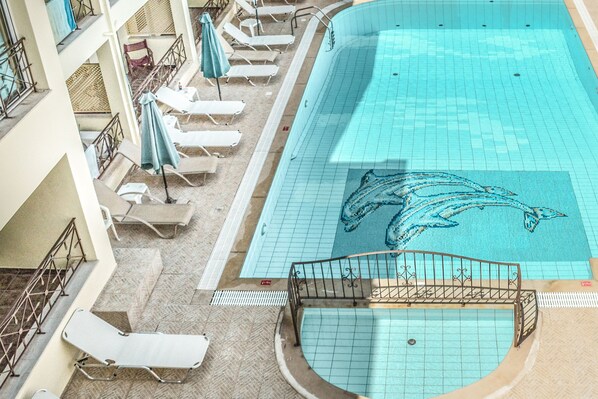 Alberca al aire libre por temporada y sombrillas en la alberca